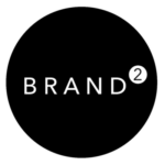 Das Bild zeigt ein kreisförmiges, schwarz-weißes Logo mit dem Wort "BRAND" und einem hochgestellten "2".