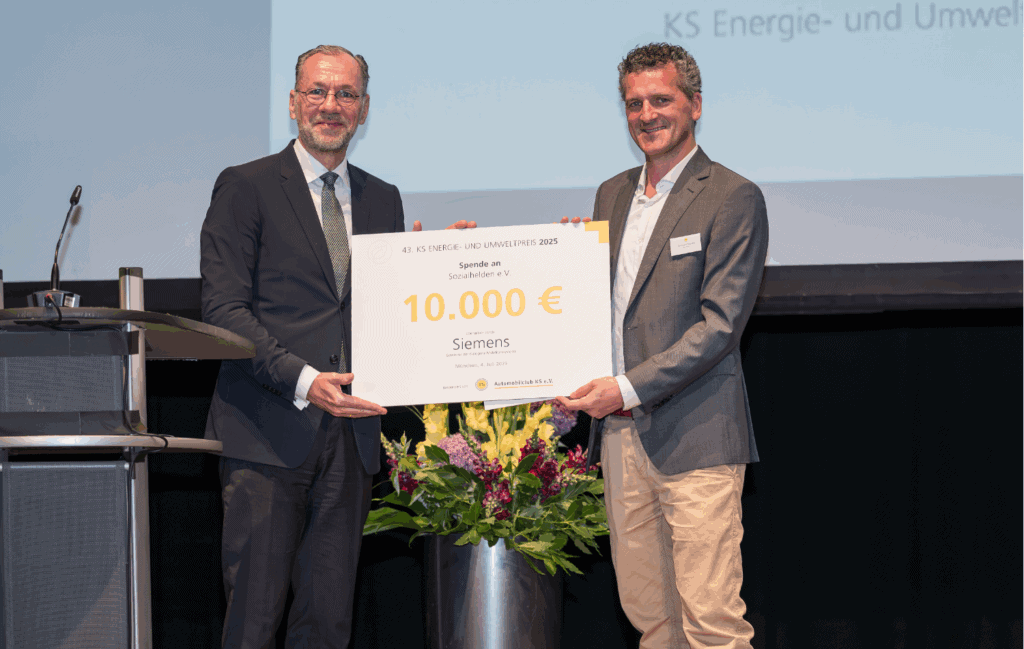 Auf dem Bild wird eine feierliche Spendenübergabe im Rahmen des 43. KS Energie- und Umweltpreises 2025 dargestellt, bei der eine Summe von 10.000 € an den Verein Sozialhelden e.V. übergeben wird. Prominente Sponsoren, darunter Siemens, unterstützen damit innovative soziale Projekte und fördern nachhaltige Lösungen für umweltbewusste Initiativen.